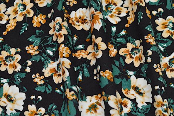 Rayon Challis Black fabric with green and tan floral print